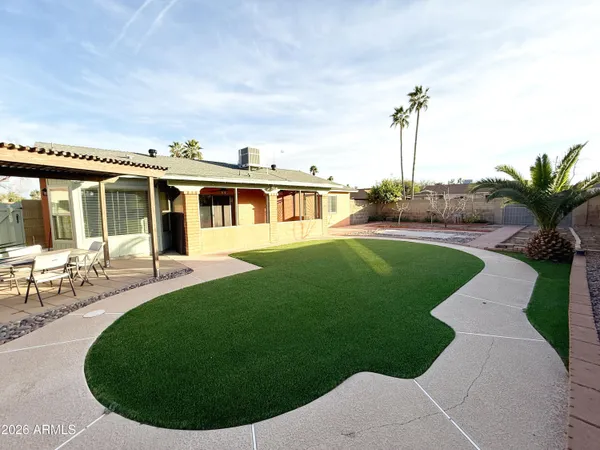 a view of a house with a backyard porch and sitting area