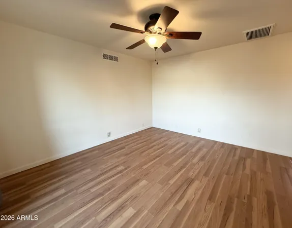 a view of a room with a ceiling fan