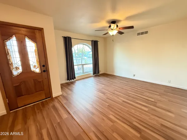 wooden floor in an empty room with a window