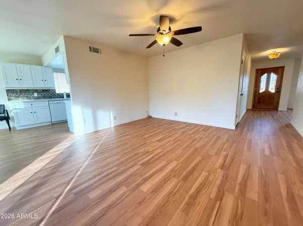 a view of empty room with wooden floor