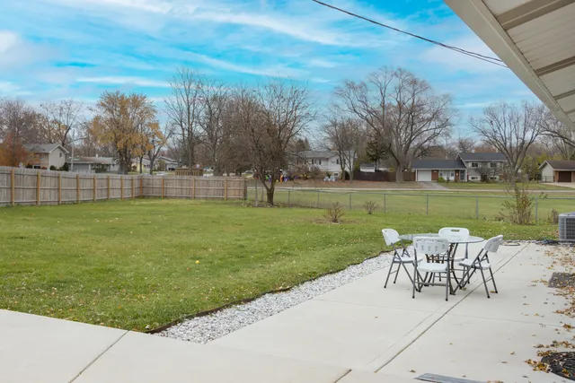 a view of a swimming pool with a garden and trees