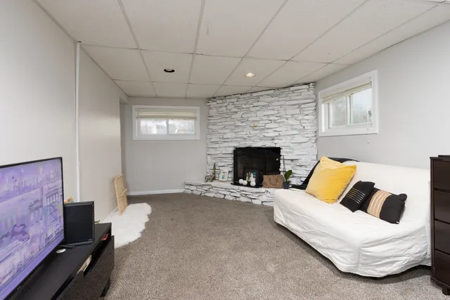 a living room with furniture and a fireplace