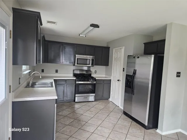 a kitchen with a refrigerator sink and microwave