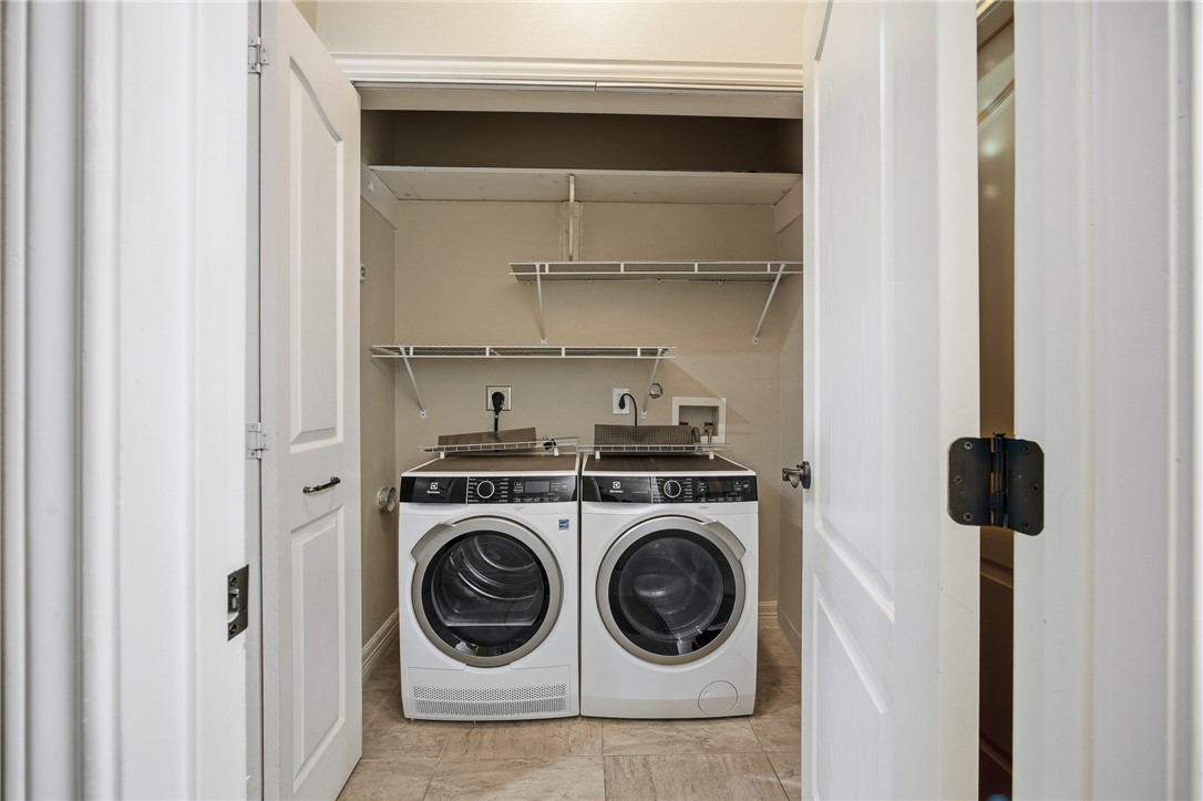 6934 Wooldridge Road, Unit R5 Corpus Christi, TX 78414 - Photo 14 of 32 a utility room with dryer and washer