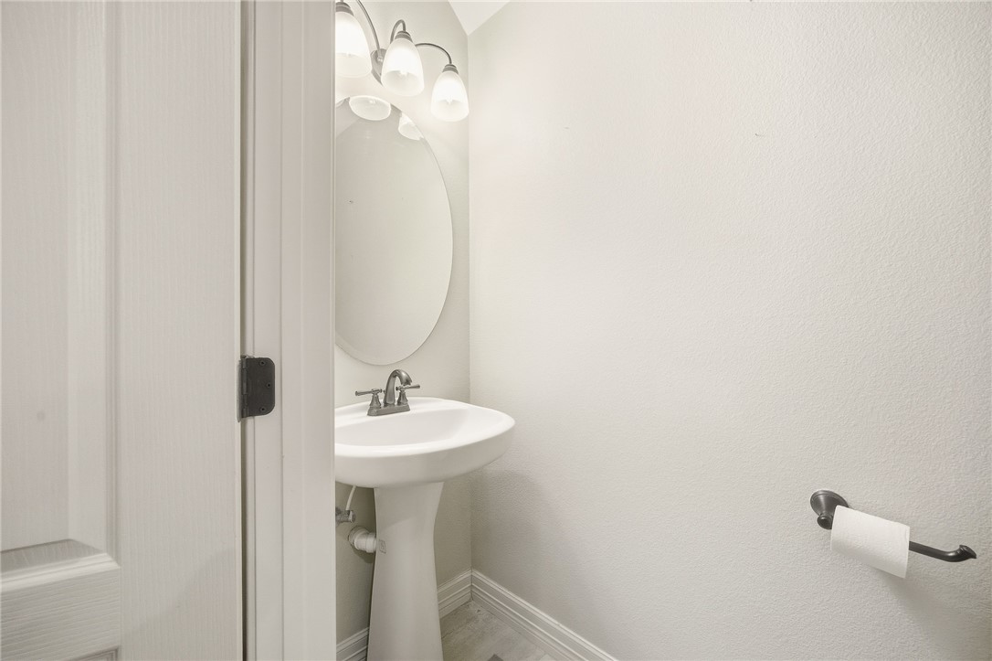 6934 Wooldridge Road, Unit R5 Corpus Christi, TX 78414 - Photo 15 of 32 a bathroom with a sink a mirror and vanity