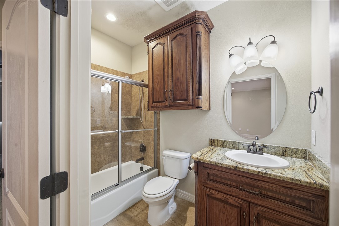 6934 Wooldridge Road, Unit R5 Corpus Christi, TX 78414 - Photo 22 of 32 a bathroom with a granite countertop sink toilet and shower