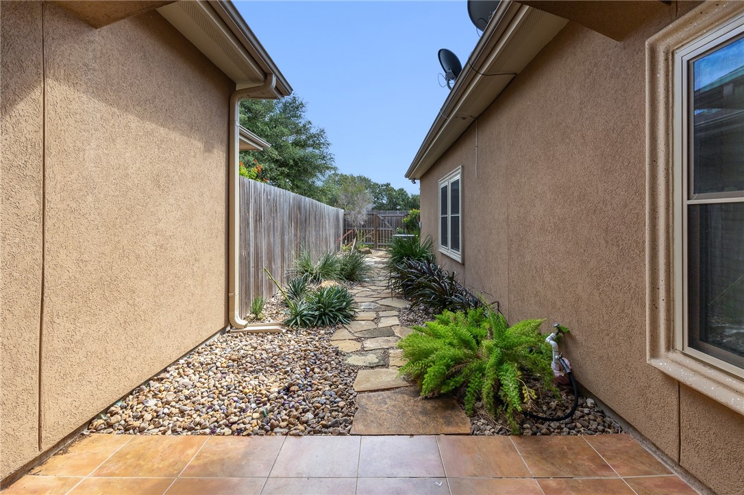 6934 Wooldridge Road, Unit R5 Corpus Christi, TX 78414 - Photo 30 of 32 a couple of potted plants in front of door