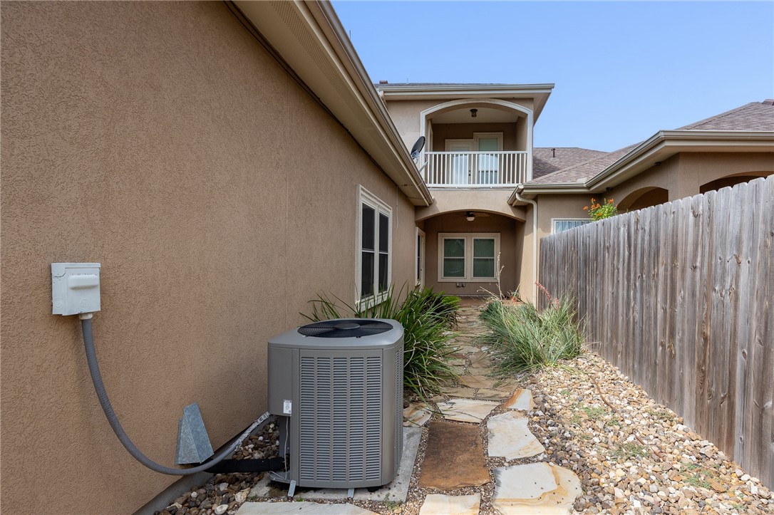 6934 Wooldridge Road, Unit R5 Corpus Christi, TX 78414 - Photo 31 of 32 a front view of a house with garden