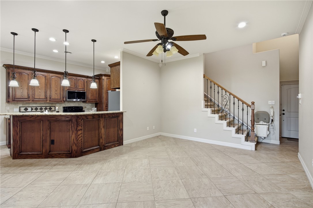 6934 Wooldridge Road, Unit R5 Corpus Christi, TX 78414 - Photo 4 of 32 a view of a kitchen with kitchen appliances and a ceiling fan