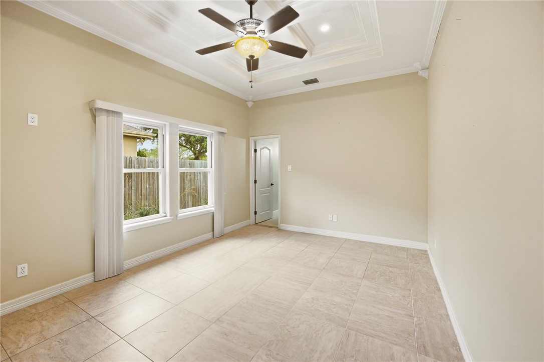 6934 Wooldridge Road, Unit R5 Corpus Christi, TX 78414 - Photo 10 of 32 an empty room with windows and fan