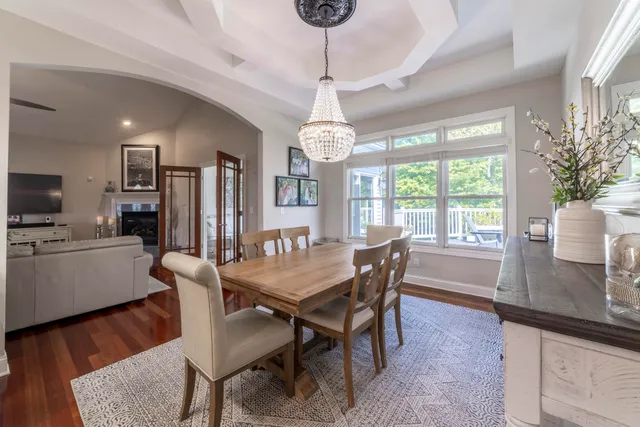 a living room with furniture flat screen tv and a table