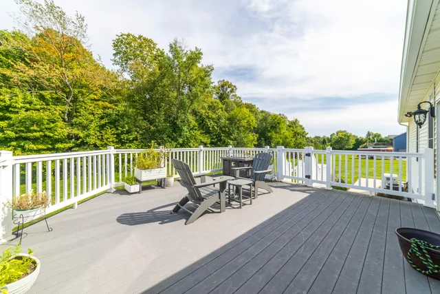 a kitchen with stainless steel appliances granite countertop a refrigerator a sink and wooden cabinets