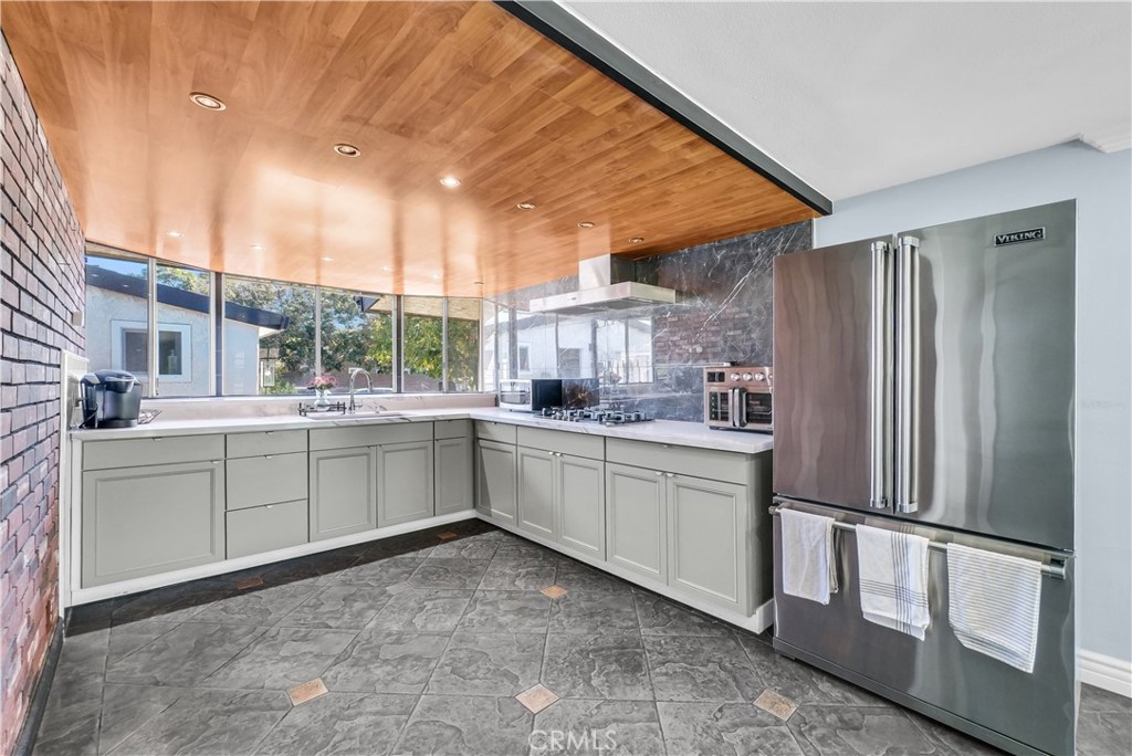 645 South Trident Street Anaheim, CA 92804 - Photo 13 of 30 a kitchen with white cabinets and white appliances