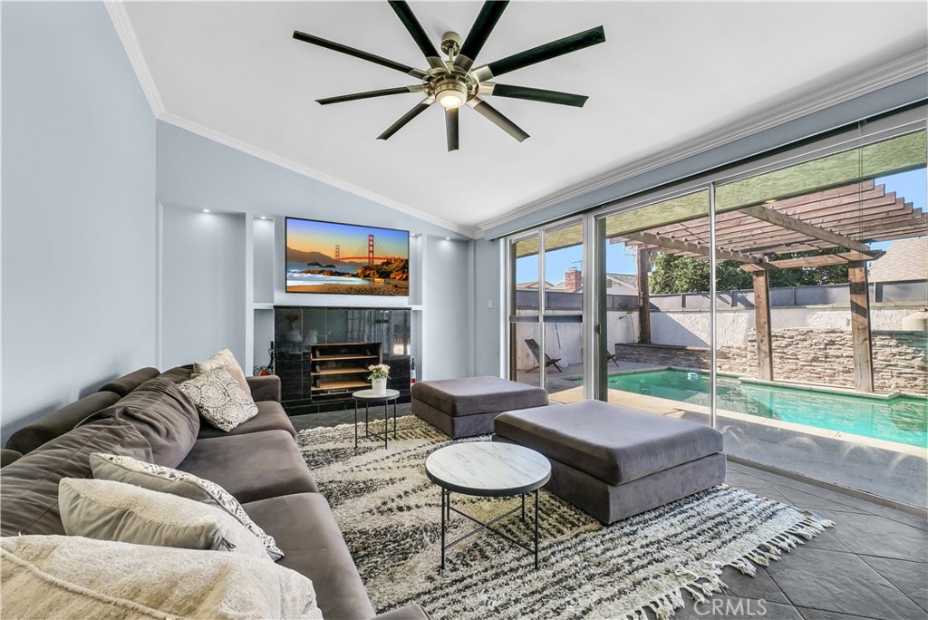 645 South Trident Street Anaheim, CA 92804 - Photo 14 of 30 a living room with furniture a fireplace and a large window with garden view