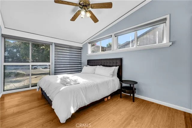 a bedroom with a bed chandelier and a window