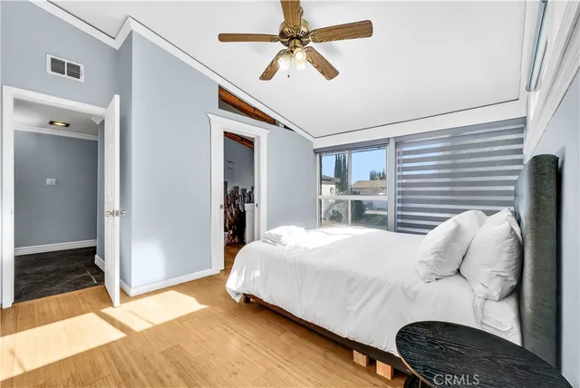 a bedroom with a bed and a window