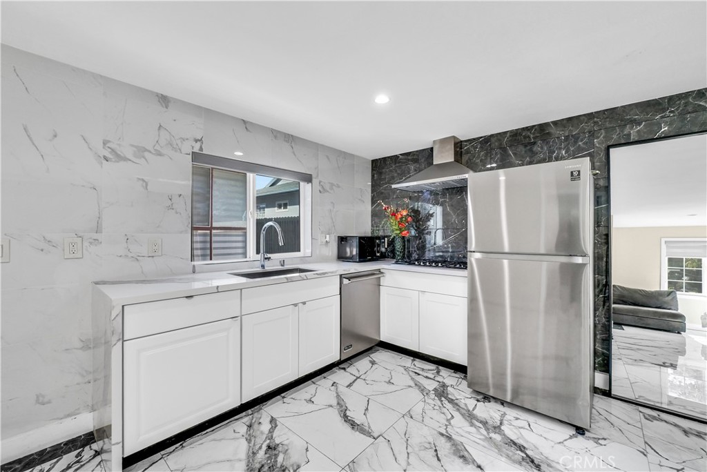 645 South Trident Street Anaheim, CA 92804 - Photo 24 of 30 a kitchen with white cabinets and refrigerator