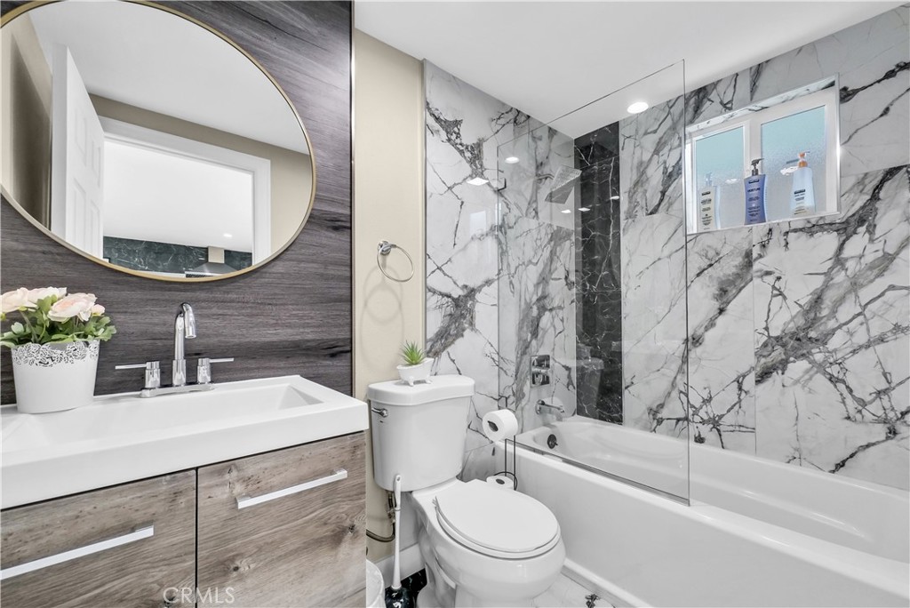 645 South Trident Street Anaheim, CA 92804 - Photo 28 of 30 a bathroom with a sink a toilet and a mirror