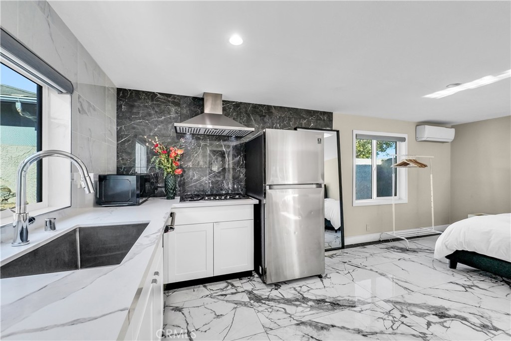 645 South Trident Street Anaheim, CA 92804 - Photo 29 of 30 a kitchen with a refrigerator sink and cabinets