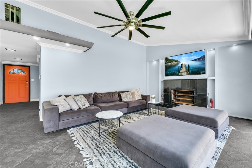 645 South Trident Street Anaheim, CA 92804 - Photo 4 of 30 a living room with furniture a fireplace and a flat screen tv