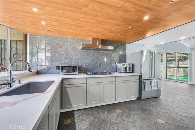 a kitchen with stainless steel appliances granite countertop a sink and cabinets