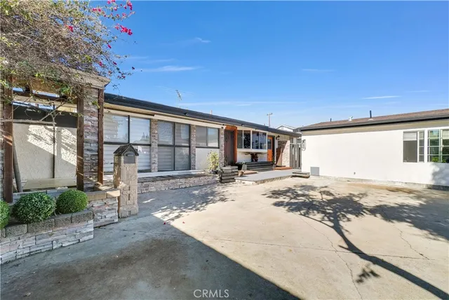a view of a house with snow on the road