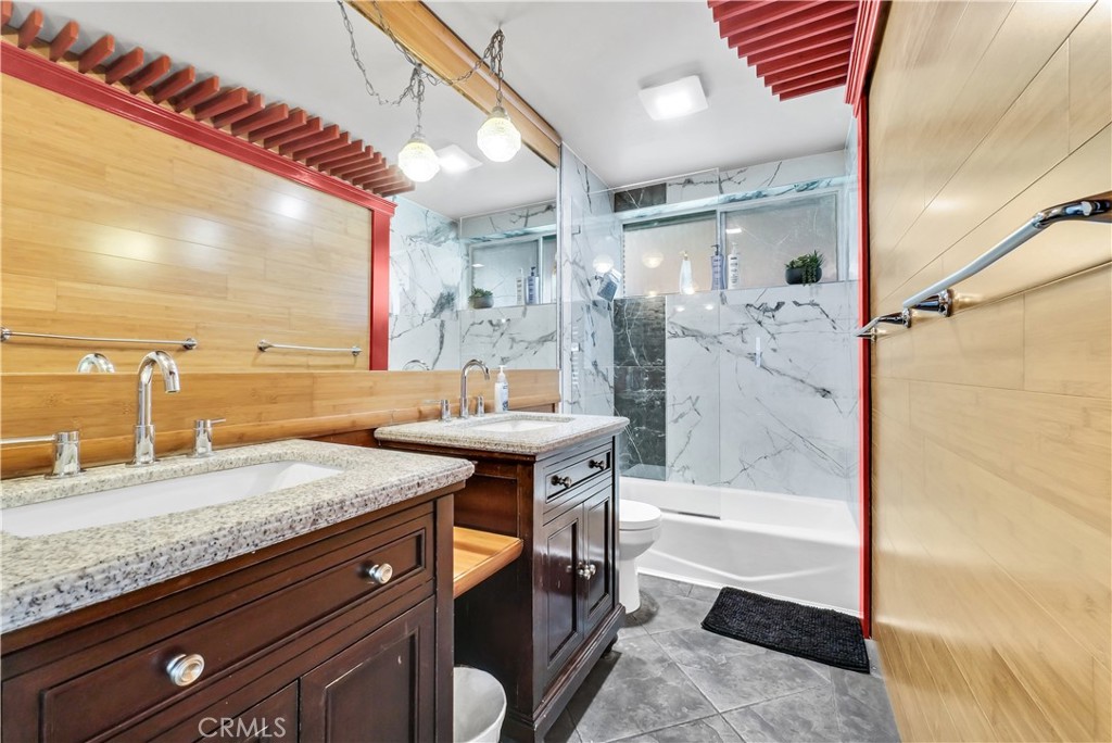 645 South Trident Street Anaheim, CA 92804 - Photo 8 of 30 a bathroom with a granite countertop sink and a mirror