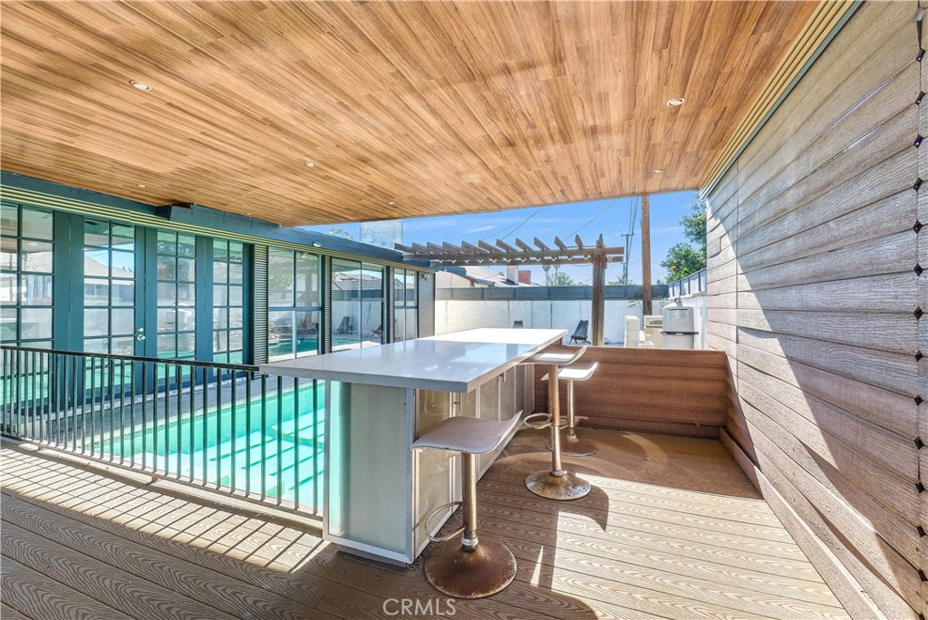 645 South Trident Street Anaheim, CA 92804 - Photo 10 of 30 a view of a patio with a table and chairs and wooden floor