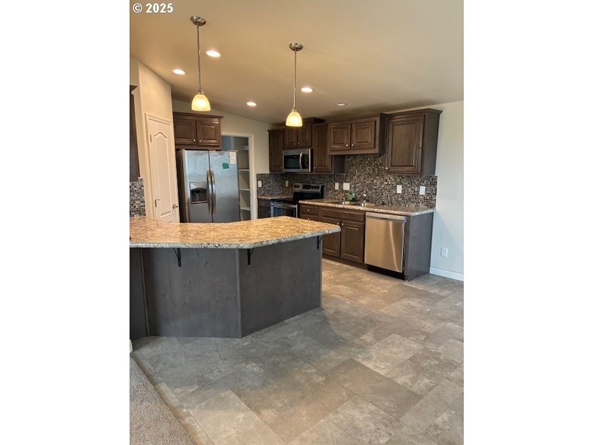 3108 Southwest River View Drive Pendleton, OR 97801 - Photo 16 of 37 a large kitchen with kitchen island a sink counter top space and stainless steel appliances