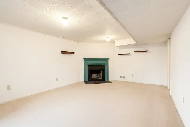 a view of an empty room with a fireplace