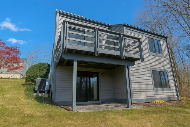a view of a house with a door and wooden wall