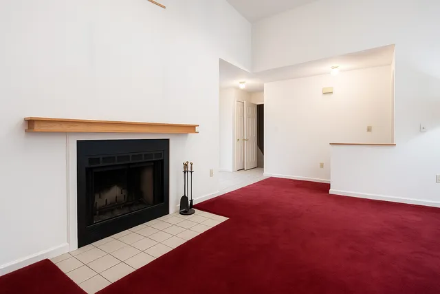 a view of an empty room with a fireplace