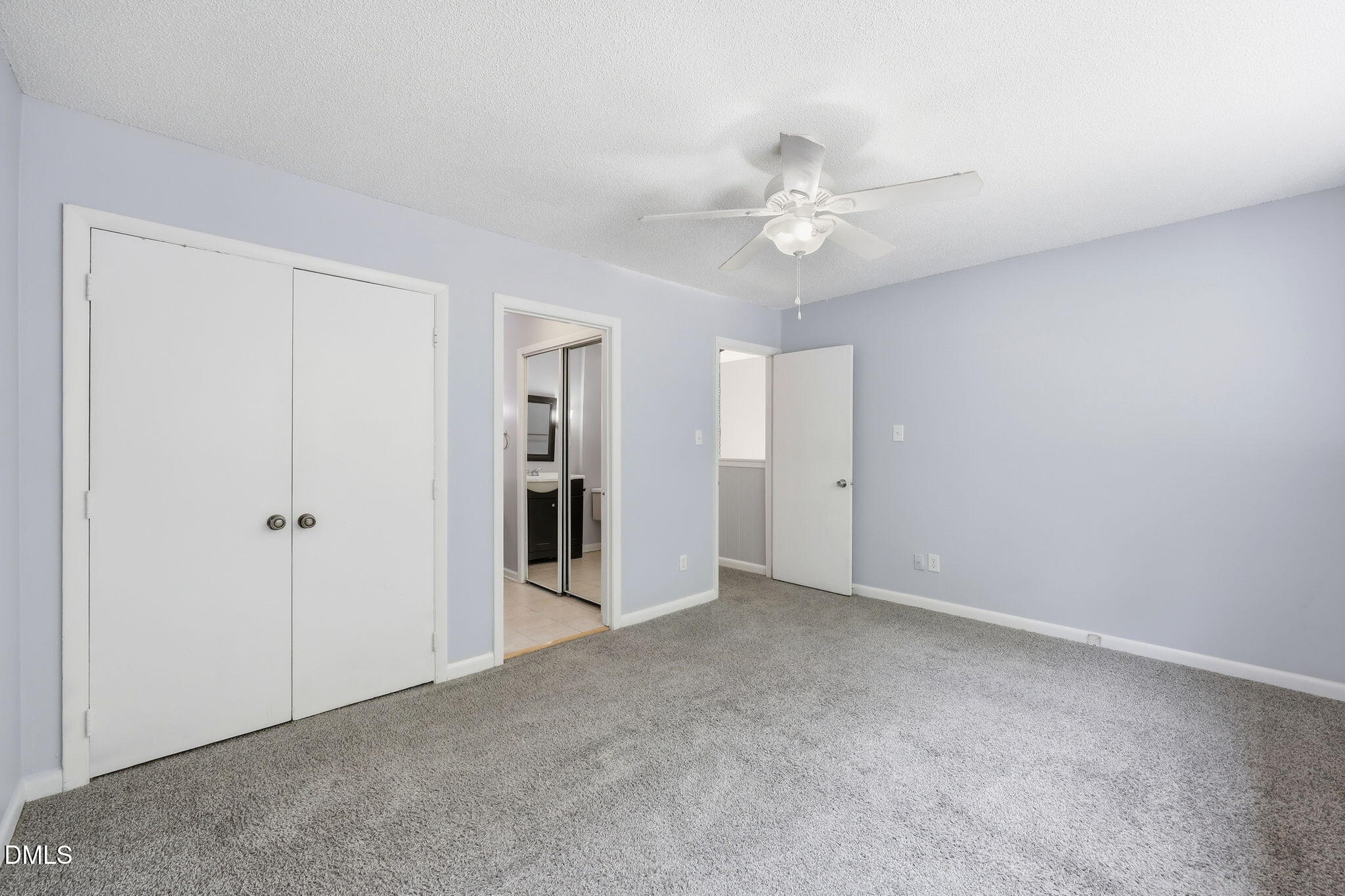 5043 Tall Pines Court Raleigh, NC 27609 - Photo 17 of 37 an empty room with closet and a ceiling fan