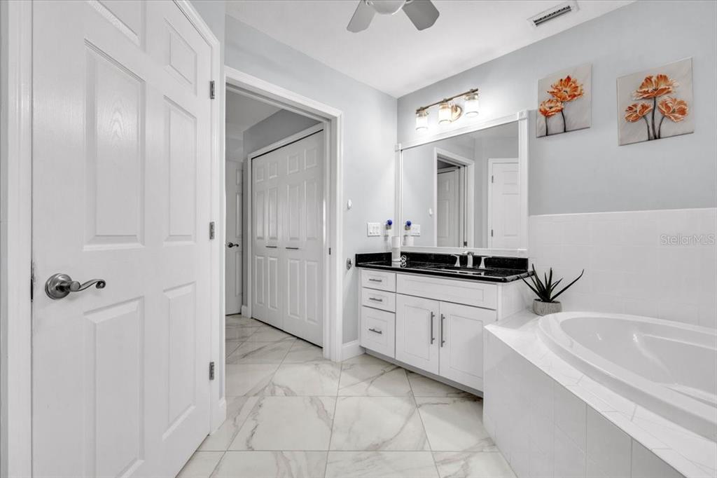 1260 Rio De Janeiro Avenue, Unit 102 Punta Gorda, FL 33983 - Photo 27 of 46 a bathroom with a tub sink and a mirror
