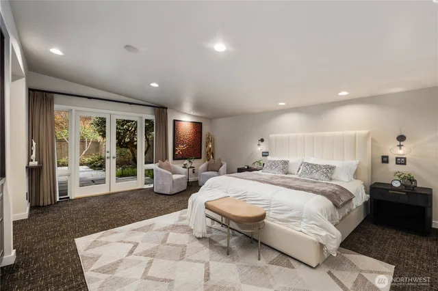 a bedroom with a large bed and a flat screen tv