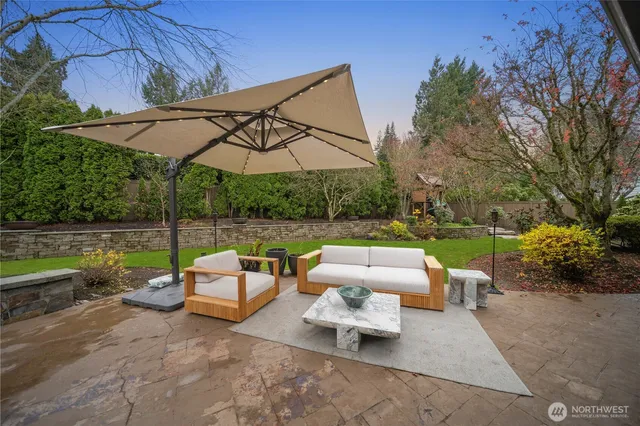 a backyard of a house with yard table and chairs