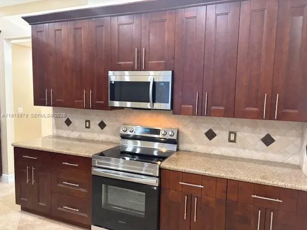 a kitchen with a sink stove and microwave