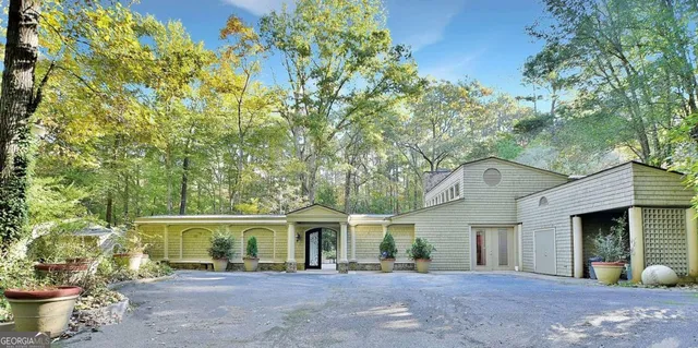 a front view of a house with a yard and outdoor seating