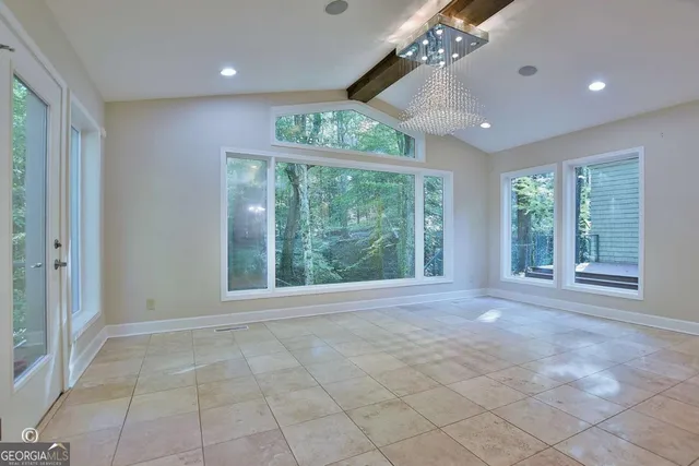 a view of an entryway with a floor to ceiling window and a living room