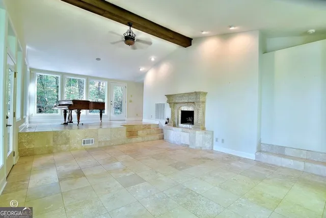 a bedroom with furniture and a large window