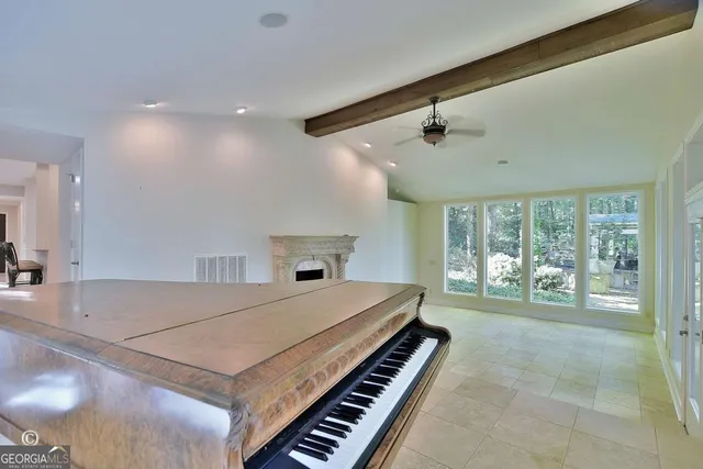 a living room with furniture a flat screen tv and a fireplace