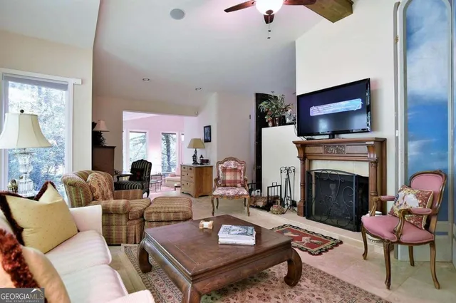 a view of an empty room with a floor to ceiling window and chandelier