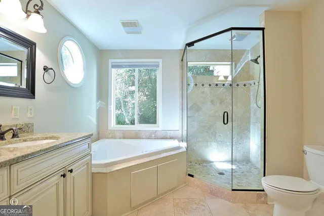 a bathroom with a granite countertop sink mirror and a shower