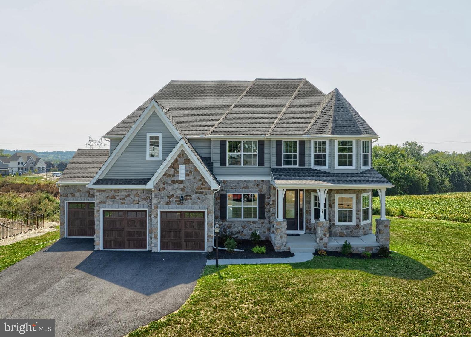 a front view of a house with a garden and yard