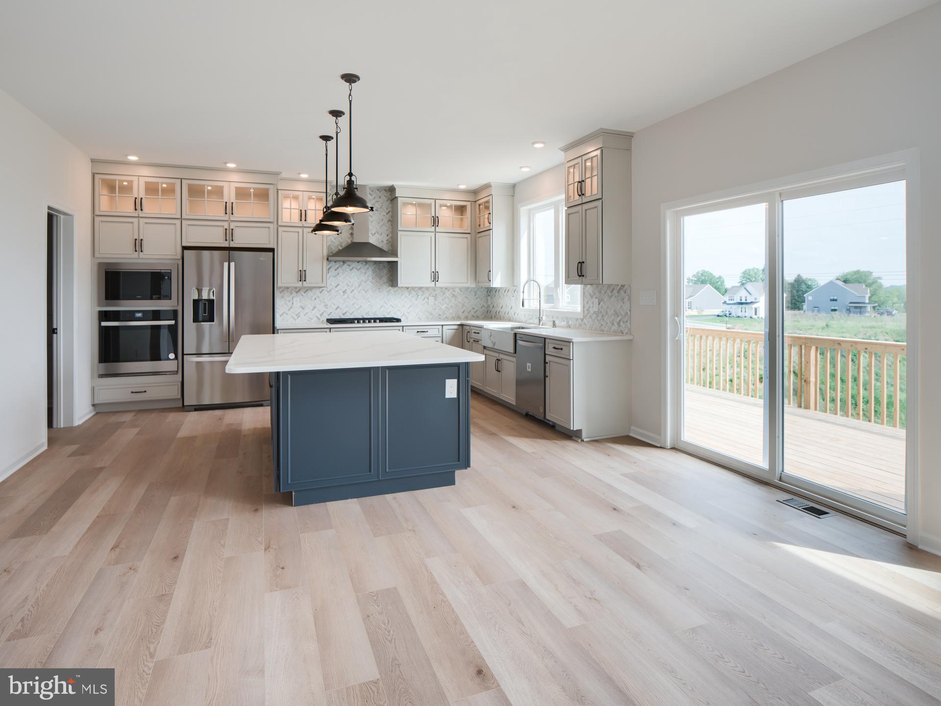 232 West Side Drive Lititz, PA 17543 - Photo 19 of 27 a large kitchen with stainless steel appliances granite countertop a lot of counter space and wooden floors