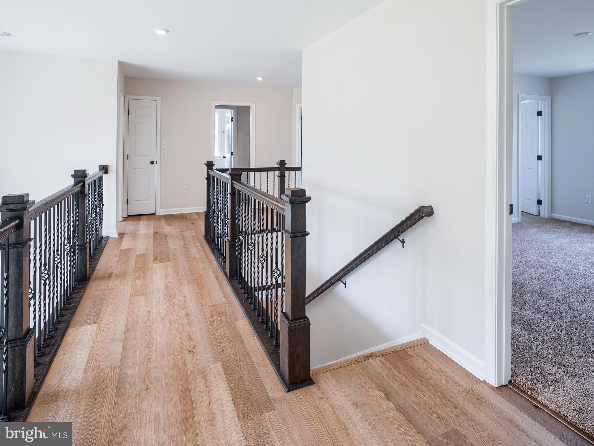 232 West Side Drive Lititz, PA 17543 - Photo 21 of 27 a view of a hallway with wooden floor and stairs