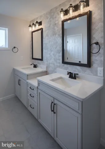 a bathroom with a double vanity sink mirror and