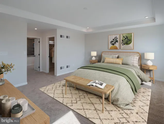 a bedroom with a bed and a couch