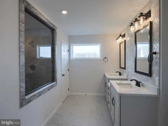 a bathroom with a sink and mirror