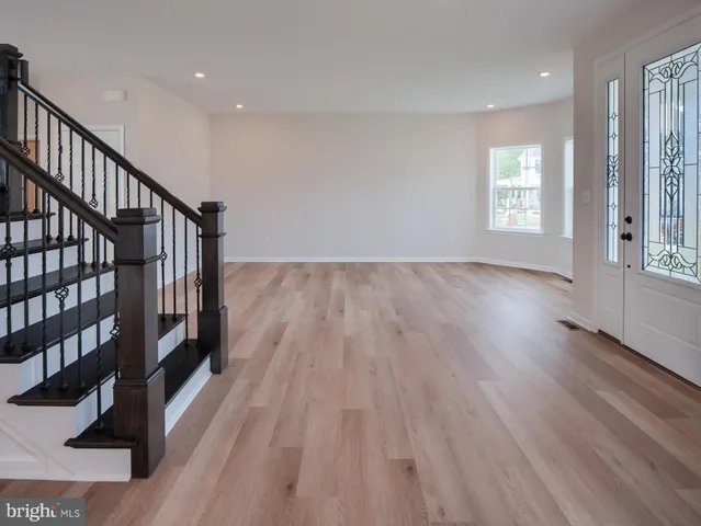a view of an entryway with wooden floor